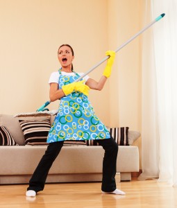 funny woman mopping floor and playing. beautiful girl playing music using mop